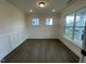 Bright living room featuring modern wainscoting, hardwood floors, and large windows for natural light at 113 Arundel Dr, Archer Lodge, NC 27527