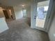 Open loft with carpeting, a sliding door to a deck, and natural light, offering a versatile living area at 113 Arundel Dr, Archer Lodge, NC 27527