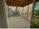 Relaxing screened-in porch with wood flooring, a wood ceiling, and views of the wooded backyard at 113 Arundel Dr, Archer Lodge, NC 27527