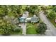 Aerial view of a home with mature trees, a long driveway, and lush landscaping at 1146 Rogers Rd, Graham, NC 27253