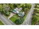 Landscaped home with a vibrant green roof, carport, and an extensive driveway at 1146 Rogers Rd, Graham, NC 27253