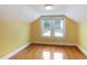 Attic bedroom features wood floors, yellow walls, and natural light at 1146 Rogers Rd, Graham, NC 27253