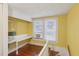 Upstairs attic space with small sink, wooden floor, and window with blinds at 1146 Rogers Rd, Graham, NC 27253