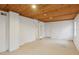 Finished basement with carpet, wood ceiling, an access door, and a small window at 1146 Rogers Rd, Graham, NC 27253