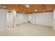 Spacious finished basement with carpet, wood ceiling, and access to an unfinished area with a sink at 1146 Rogers Rd, Graham, NC 27253