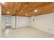 Partially finished basement with painted walls, carpet floors and natural light coming in from a window at 1146 Rogers Rd, Graham, NC 27253