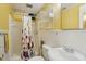 Bathroom with sink, toilet, vanity and shower/bath with floral curtain at 1146 Rogers Rd, Graham, NC 27253