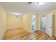 A bedroom with a light yellow paint job, wood floors and a door leading to the bathroom at 1146 Rogers Rd, Graham, NC 27253