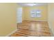 Bedroom boasts wood floors, a window, and a door to access at 1146 Rogers Rd, Graham, NC 27253