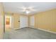 Bedroom with neutral carpet and yellow walls features a closet and doorway to other room at 1146 Rogers Rd, Graham, NC 27253