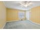 Bright bedroom featuring neutral carpet, yellow walls, and a window with shutter-style blinds at 1146 Rogers Rd, Graham, NC 27253