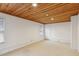This bedroom has carpeted floors, white walls and a wood plank ceiling at 1146 Rogers Rd, Graham, NC 27253