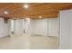 This bedroom has neutral color, white walls and closet doors, and concrete flooring at 1146 Rogers Rd, Graham, NC 27253