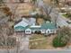 A charming home with green roof, white siding, mature trees, and spacious front yard at 1146 Rogers Rd, Graham, NC 27253