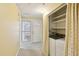 Laundry room showcases a washer/dryer, shelving and a door to the outside at 1146 Rogers Rd, Graham, NC 27253