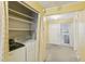 Laundry room complete with shelving and a curtain for privacy at 1146 Rogers Rd, Graham, NC 27253