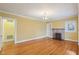 Comfortable living room with hardwood floors, fireplace, built-in bookshelves, and a vintage light fixture at 1146 Rogers Rd, Graham, NC 27253