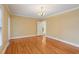 Open living room with hardwood floors and a doorway leading to another room at 1146 Rogers Rd, Graham, NC 27253