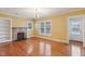Cozy living room features hardwood floors, a fireplace, built-in bookshelves, and large windows at 1146 Rogers Rd, Graham, NC 27253