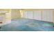 Large yellow room featuring blue carpeting and access to kitchen and hallway at 1146 Rogers Rd, Graham, NC 27253