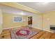 This living room has wood floors, yellow walls, and natural light from a window at 1146 Rogers Rd, Graham, NC 27253