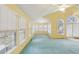 Bright living room with vaulted ceilings, many windows, and teal carpet at 1146 Rogers Rd, Graham, NC 27253
