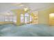 Large yellow living room featuring blue carpeting and access to kitchen and dining at 1146 Rogers Rd, Graham, NC 27253