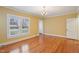 This living room has hardwood floors, yellow walls, and natural light from a window at 1146 Rogers Rd, Graham, NC 27253