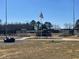 Community baseball field with bleacher seating and an American flag flying in the background at 115 Arundel Dr, Archer Lodge, NC 27527
