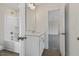 Bathroom with white vanity, shower-tub combo, and view to bedroom at 115 Arundel Dr, Archer Lodge, NC 27527