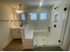Modern bathroom featuring a glass shower with built-in bench seating and a view from the windows at 115 Arundel Dr, Archer Lodge, NC 27527