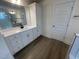 Bright bathroom with a large vanity, ample storage, and modern fixtures, all complementing the wood-look flooring at 115 Arundel Dr, Archer Lodge, NC 27527