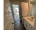 Bathroom features a vanity with a white countertop and a view into an adjacent room with natural light at 115 Arundel Dr, Archer Lodge, NC 27527