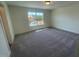Bright bedroom features neutral carpet, a large window, and ample natural light at 115 Arundel Dr, Archer Lodge, NC 27527
