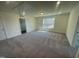 Spacious bedroom featuring neutral carpeting and natural light from a large window at 115 Arundel Dr, Archer Lodge, NC 27527