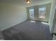 Bright bedroom features neutral carpet, two windows, and ample natural light at 115 Arundel Dr, Archer Lodge, NC 27527