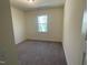 Cozy bedroom with plush carpeting and a large window overlooking the yard at 115 Arundel Dr, Archer Lodge, NC 27527
