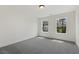 Bright bedroom with two windows and neutral gray carpet at 115 Arundel Dr, Archer Lodge, NC 27527
