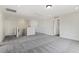 A spacious bonus room with neutral carpet, white walls and lots of doors at 115 Arundel Dr, Archer Lodge, NC 27527