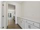 Butler's pantry with white cabinets, light countertops, and hardwood floors at 115 Arundel Dr, Archer Lodge, NC 27527