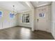 A bright foyer with hardwood floors, a chandelier, a large window, and decorative molding at 115 Arundel Dr, Archer Lodge, NC 27527