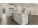 A spacious kitchen island with white cabinets and light countertops at 115 Arundel Dr, Archer Lodge, NC 27527