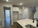 Bright kitchen with white cabinets, stainless steel appliances, and hardwood floors at 115 Arundel Dr, Archer Lodge, NC 27527