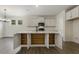 Bright kitchen features a large island with storage, white cabinets, modern appliances, and wood floors at 115 Arundel Dr, Archer Lodge, NC 27527