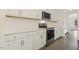 A modern kitchen with white cabinets, stainless steel appliances, and light countertops at 115 Arundel Dr, Archer Lodge, NC 27527