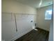 Laundry room with wood-look flooring, wire shelving, and a window at 115 Arundel Dr, Archer Lodge, NC 27527