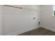 Bright laundry room with vinyl flooring, white walls, and wire shelving at 115 Arundel Dr, Archer Lodge, NC 27527