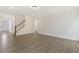 Open living room with wood floors and natural light, leading to entryway and staircase at 115 Arundel Dr, Archer Lodge, NC 27527