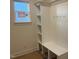 Mudroom featuring built-in shelving, seating, and hooks, next to a bright window at 115 Arundel Dr, Archer Lodge, NC 27527