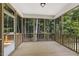 Covered porch with wood floors and screened walls, offers great view of the wooded backyard at 115 Arundel Dr, Archer Lodge, NC 27527